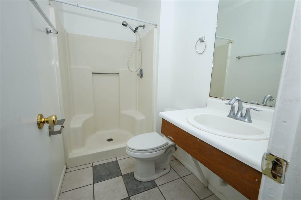 3240 Littlefield Street Deltona, FL 32738 - Photo 12 of 18 a bathroom with a sink toilet and shower