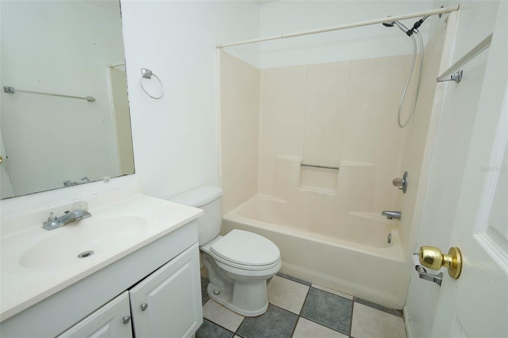 3240 Littlefield Street Deltona, FL 32738 - Photo 14 of 18 a bathroom with a sink a toilet and shower