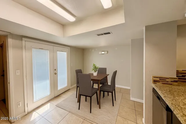 a view of a dining room with furniture and chandelier