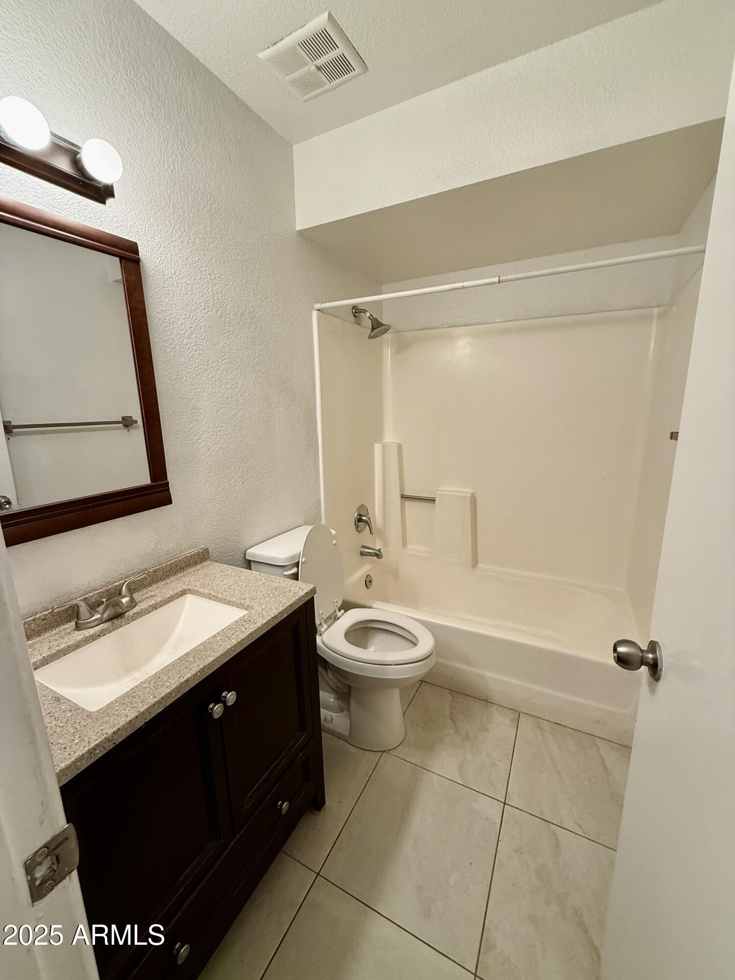19601 North 7th Street, Unit 1030 Phoenix, AZ 85024 - Photo 10 of 19 a bathroom with a double vanity sink toilet mirror and shower