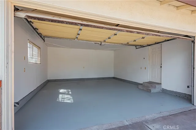 a view of a deck with chairs and wooden fence