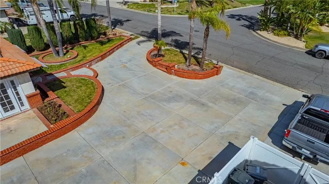 an aerial view of a house with swimming pool and large trees