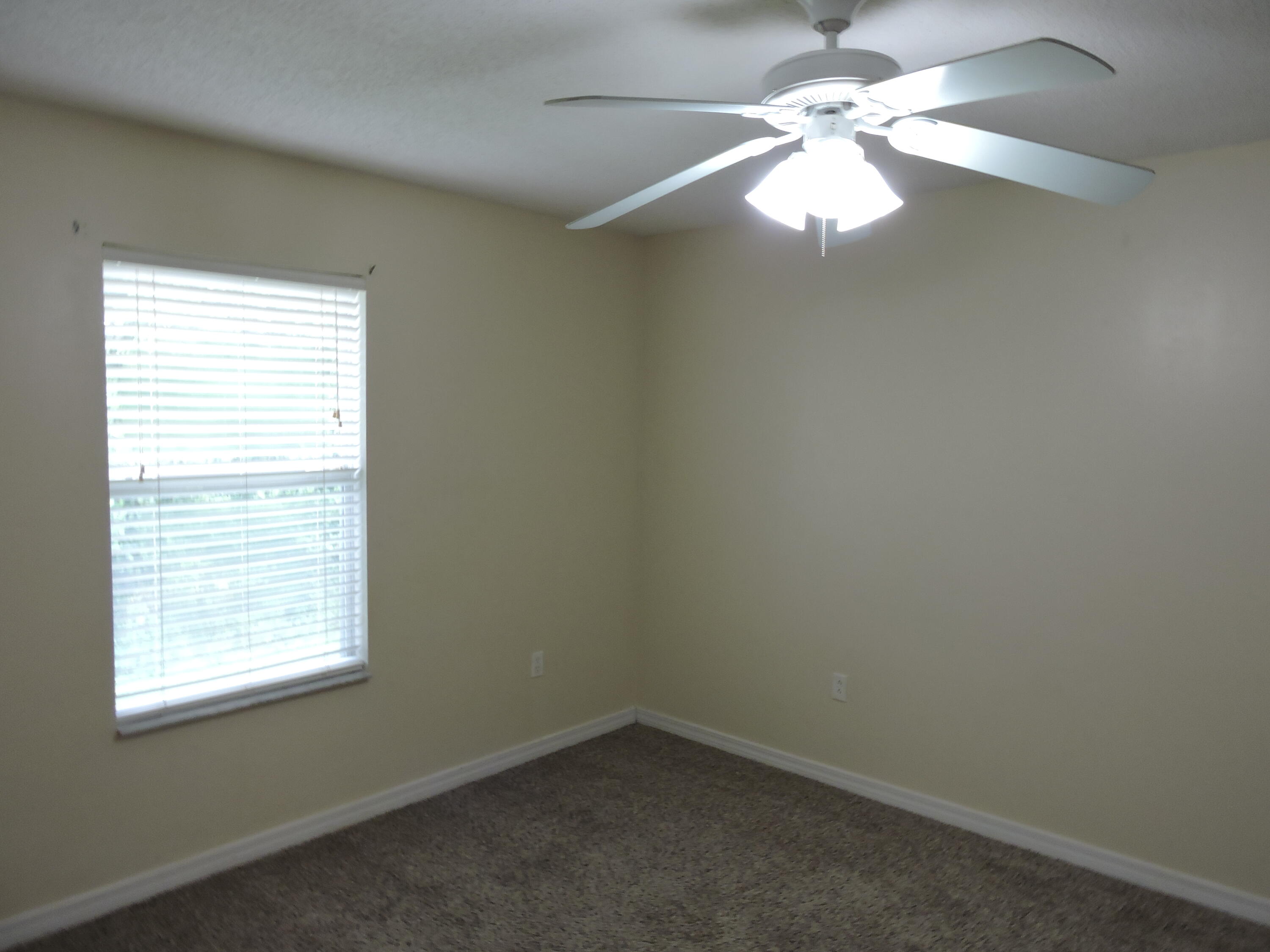 178 Cabana Way Crestview, FL 32536 - Photo 11 of 20 an empty room with a window and a fan