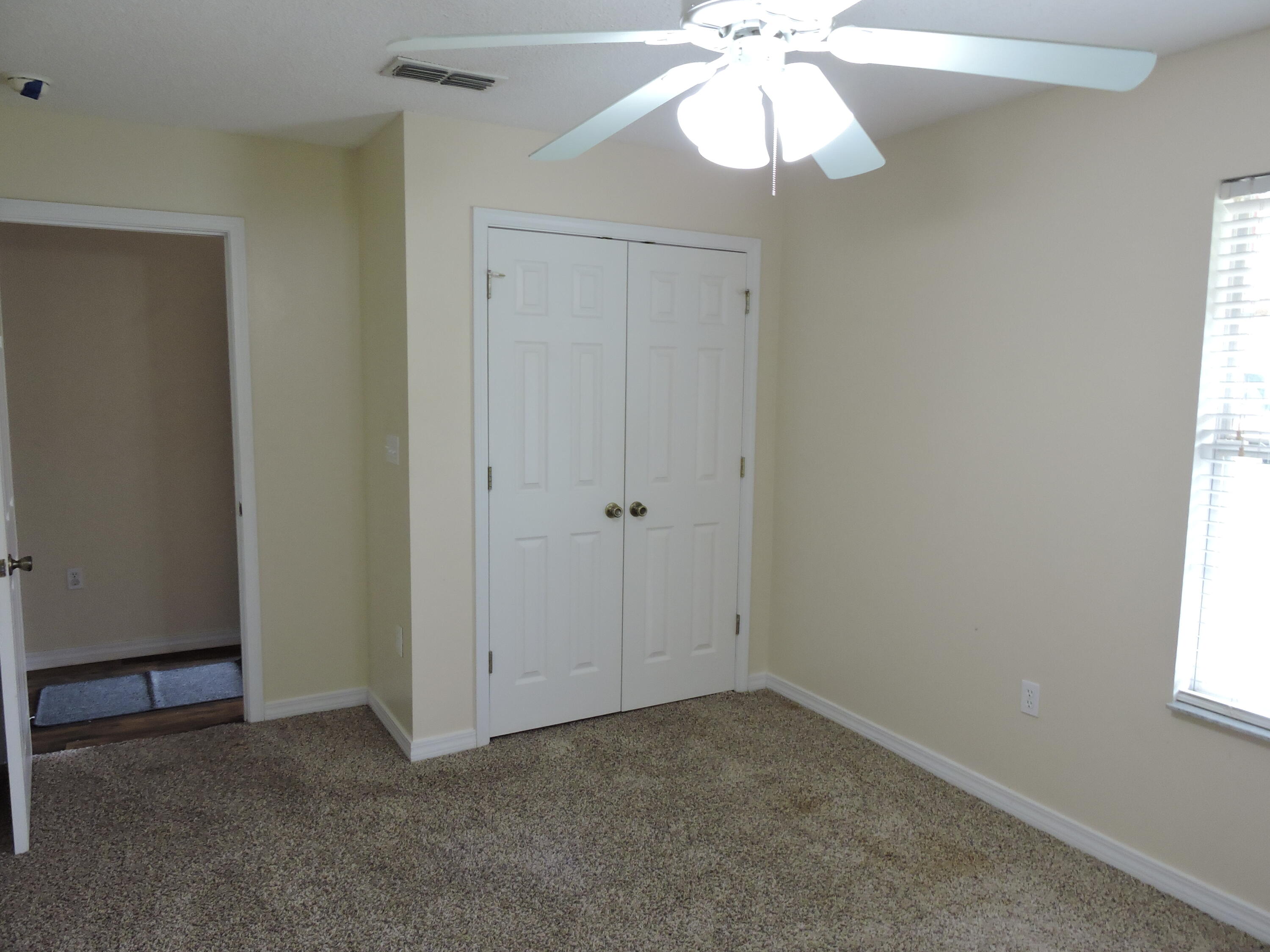 178 Cabana Way Crestview, FL 32536 - Photo 3 of 20 an empty room with a window and a fan