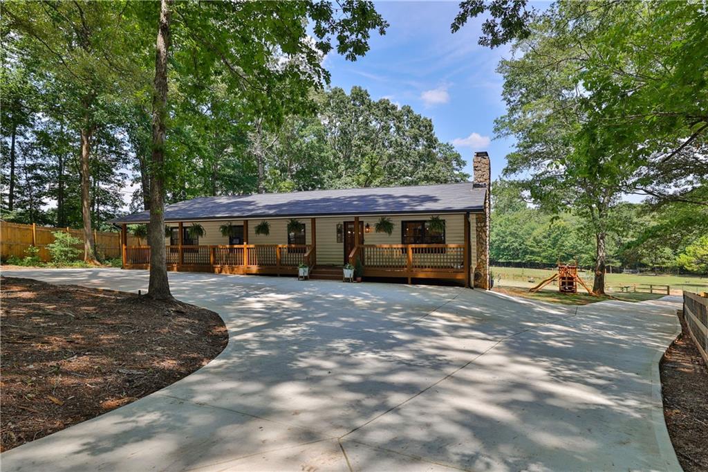 4245 Bullock Bridge Road Loganville, GA 30052 - Photo 1 of 1 a view of a house with a yard and tree s
