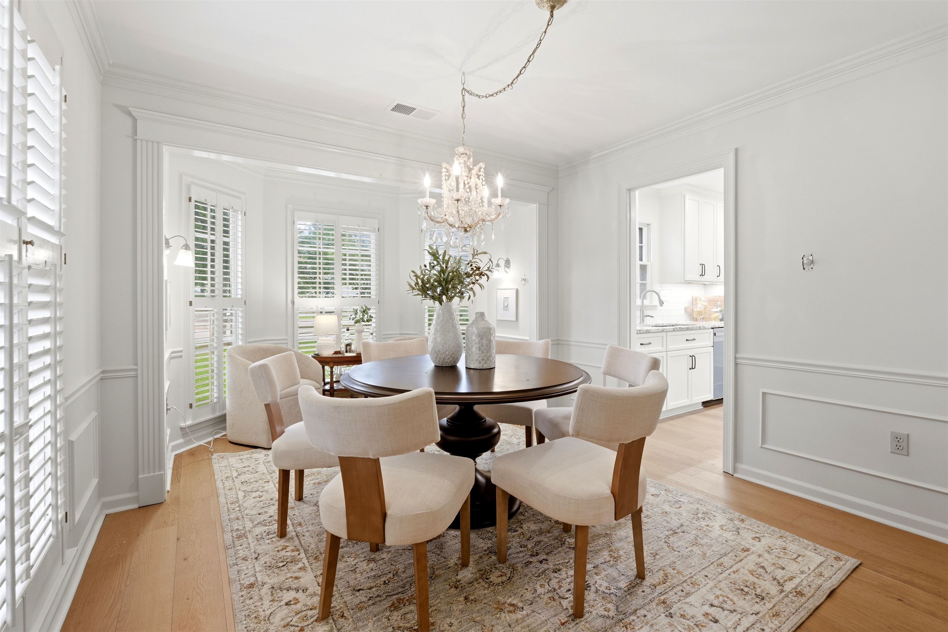 1984 Allenby Road Germantown, TN 38139 - Photo 10 of 37 Dining space featuring a crystal chandelier, hardwood flooring, and white plantation shutters