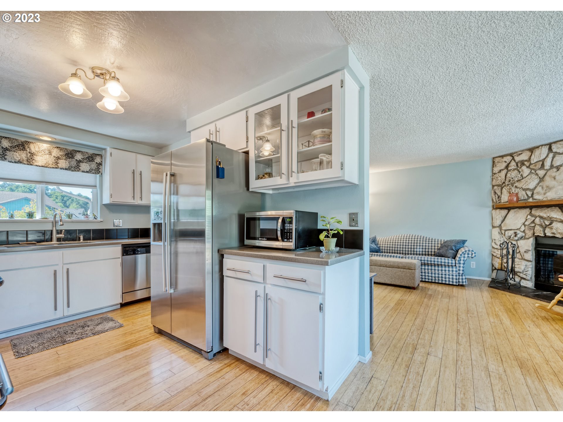 636 Island Street Springfield, OR 97477 - Photo 8 of 25 a kitchen with stainless steel appliances a stove a sink dishwasher and a refrigerator