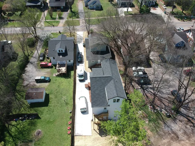 an aerial view of a house with a yard