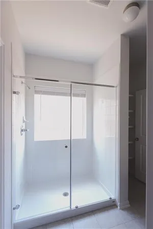 a bathroom with a glass shower door