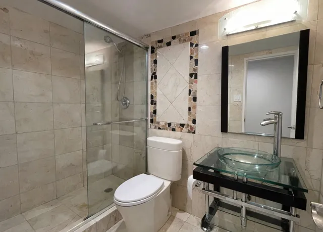 a bathroom with a sink toilet and shower