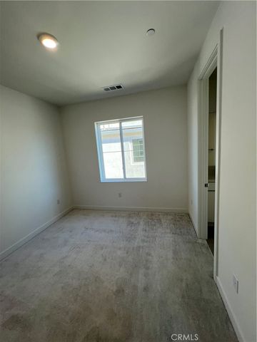 a view of an empty room with two windows