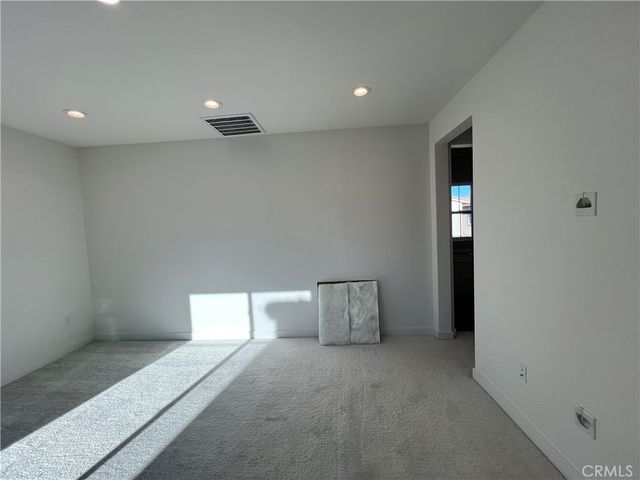 a front view of a house with a yard and palm trees