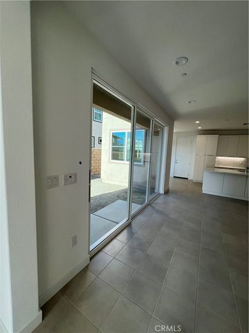 a view of a hallway with wooden floor and a cabinet