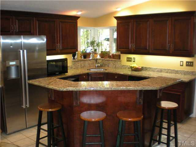 3417 Hackney Court Raleigh, NC 27613 - Photo 2 of 23 This completely updated kitchen is a chef?s dream. Beautiful granite countertops & cherry cabs, smooth-top range, double ovens, ceramic floor & skylights. Enormous amount of counter space & cabinets, as well as an island bar. Great for entertaining! Kitchen