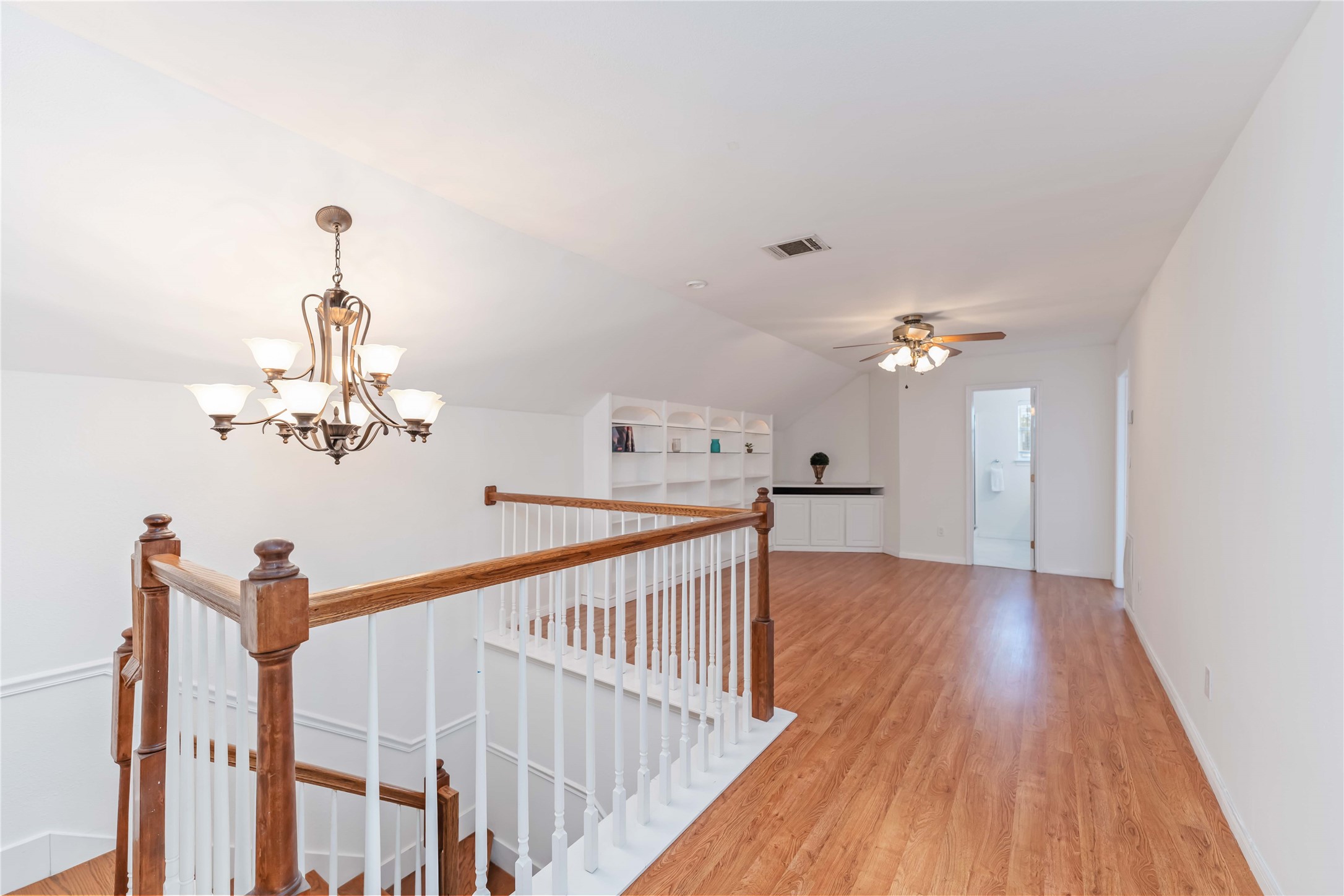 606 Packer Court Webster, TX 77598 - Photo 1 of 28 a view of a chandelier fan and wooden floor