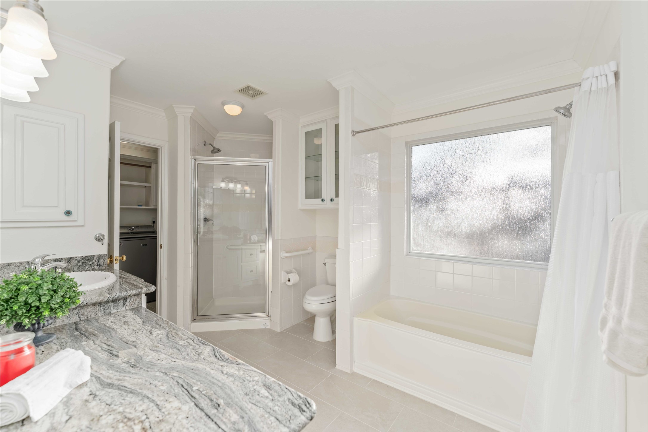 606 Packer Court Webster, TX 77598 - Photo 13 of 28 a bathroom with a glass shower door and a shower
