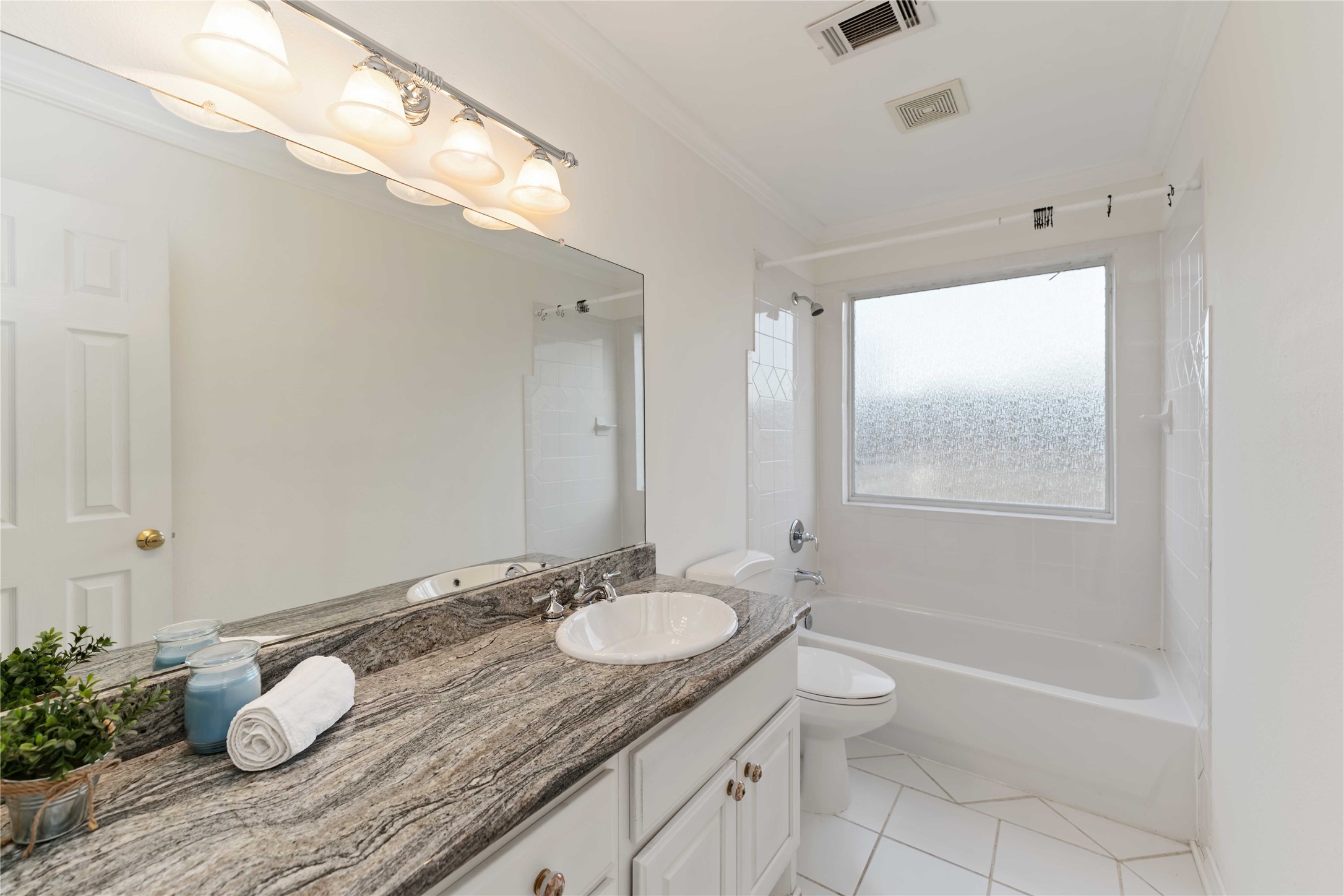 606 Packer Court Webster, TX 77598 - Photo 15 of 28 a bathroom with a granite countertop sink toilet and shower