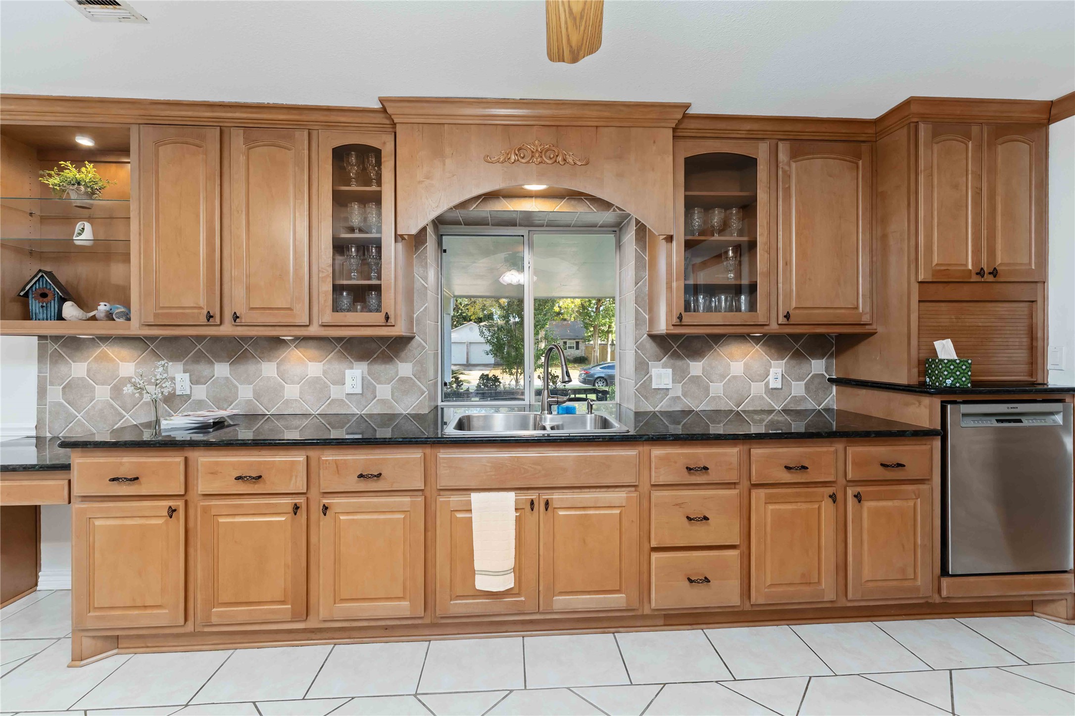 606 Packer Court Webster, TX 77598 - Photo 26 of 28 a kitchen with granite countertop white cabinets stainless steel appliances a sink and dishwasher