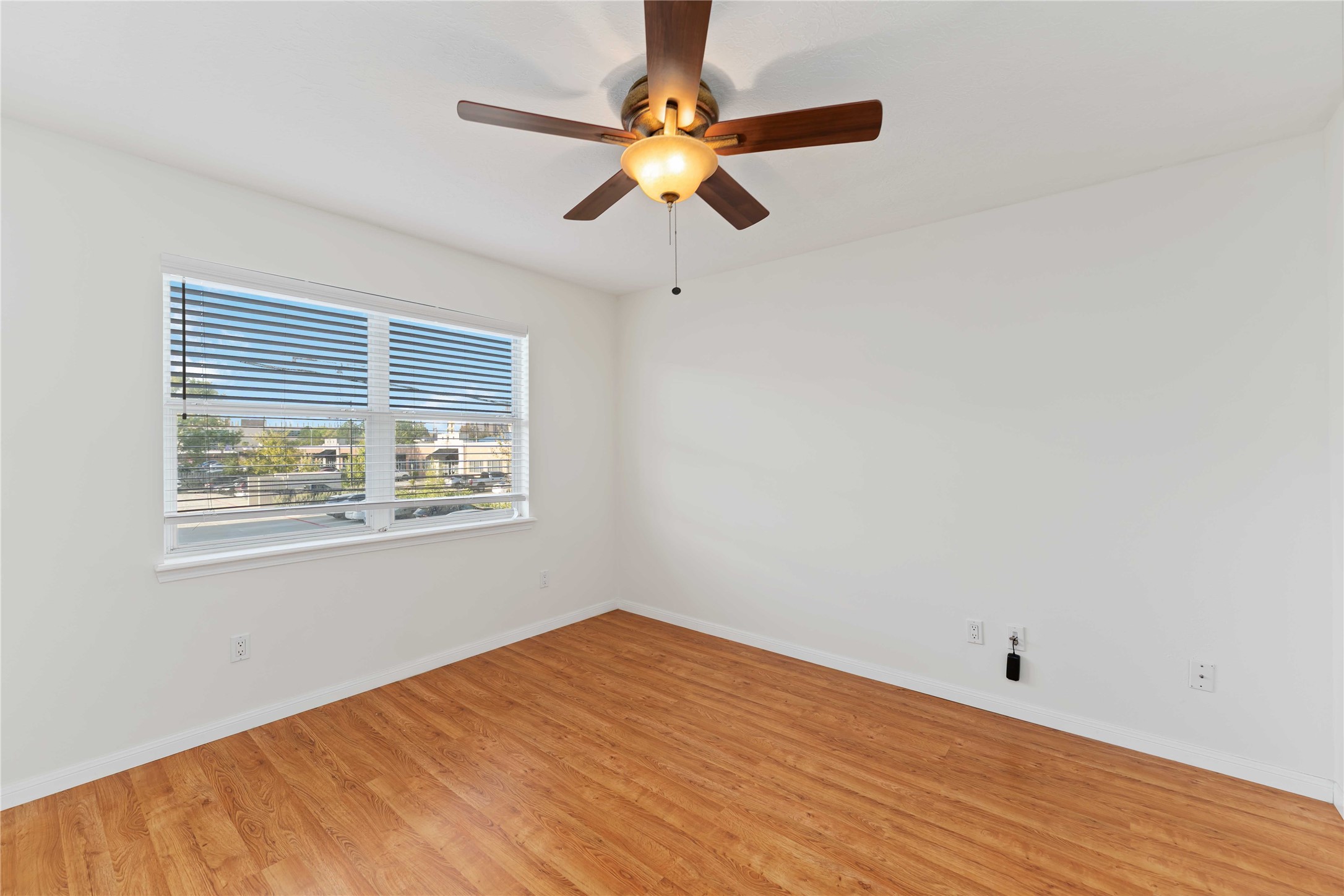 606 Packer Court Webster, TX 77598 - Photo 5 of 28 a view of an empty room with window and wooden floor