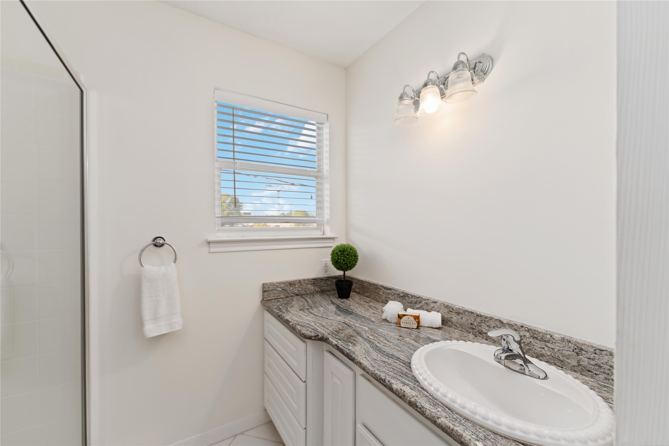 606 Packer Court Webster, TX 77598 - Photo 7 of 28 a bathroom with a granite countertop sink and a mirror