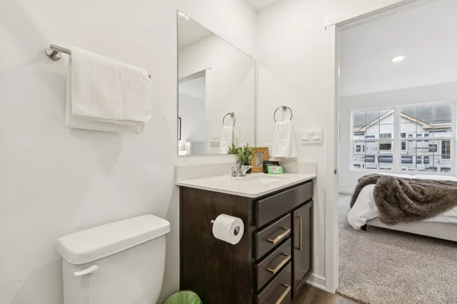 a bathroom with a sink a toilet and a mirror