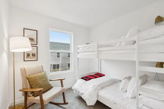 a bedroom with a bed and a chair