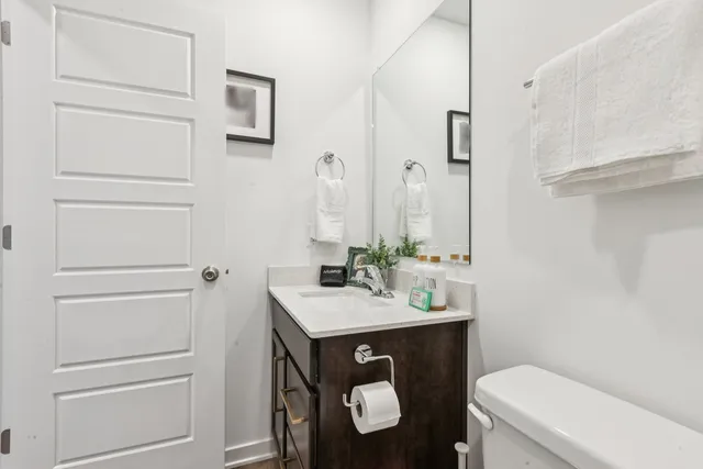 a bathroom with a sink vanity and toilet