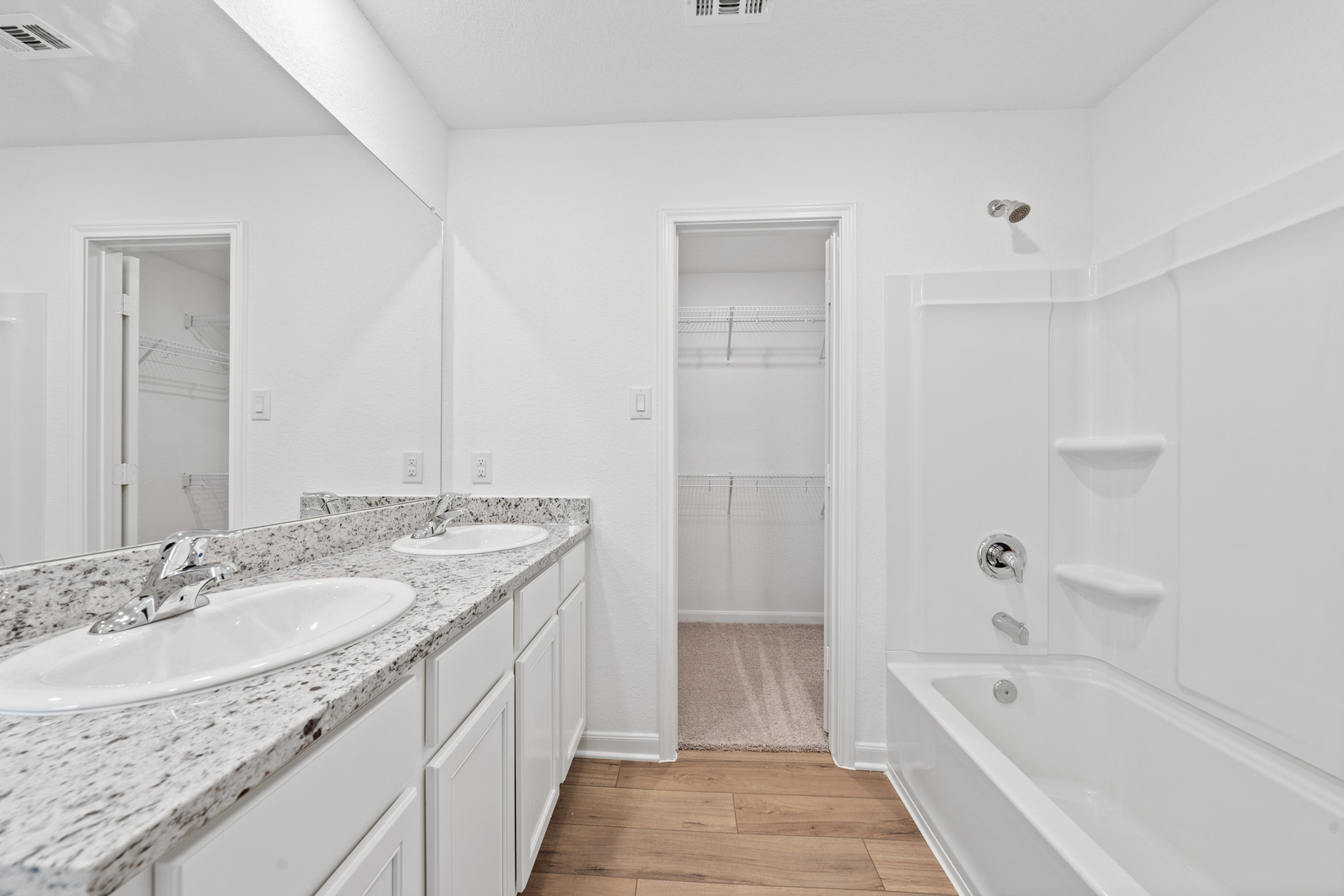 402 Aplite Pass Maxwell, TX 78656 - Photo 3 of 6 Full bath featuring a spacious closet, light wood-style flooring, double vanity, and shower / bathtub combination
