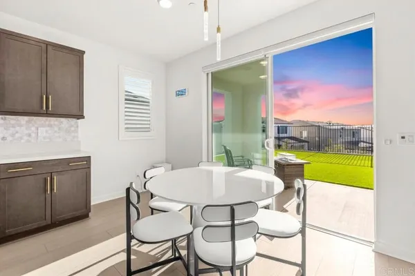a living room with furniture a dining table and kitchen view