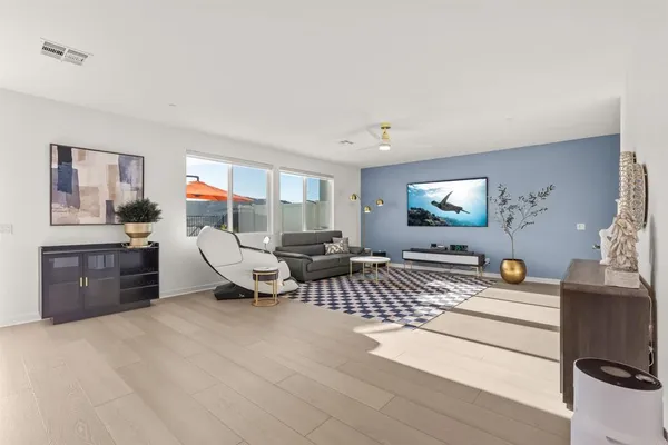 a room with furniture a rug and white walls