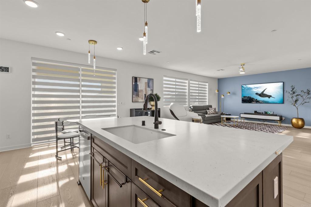 550 Meadowood Street Fallbrook, CA 92028 - Photo 19 of 37 a large kitchen with kitchen island a stove a sink a island and windows