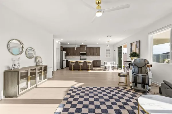 a large kitchen with kitchen island a stove a sink a island and windows