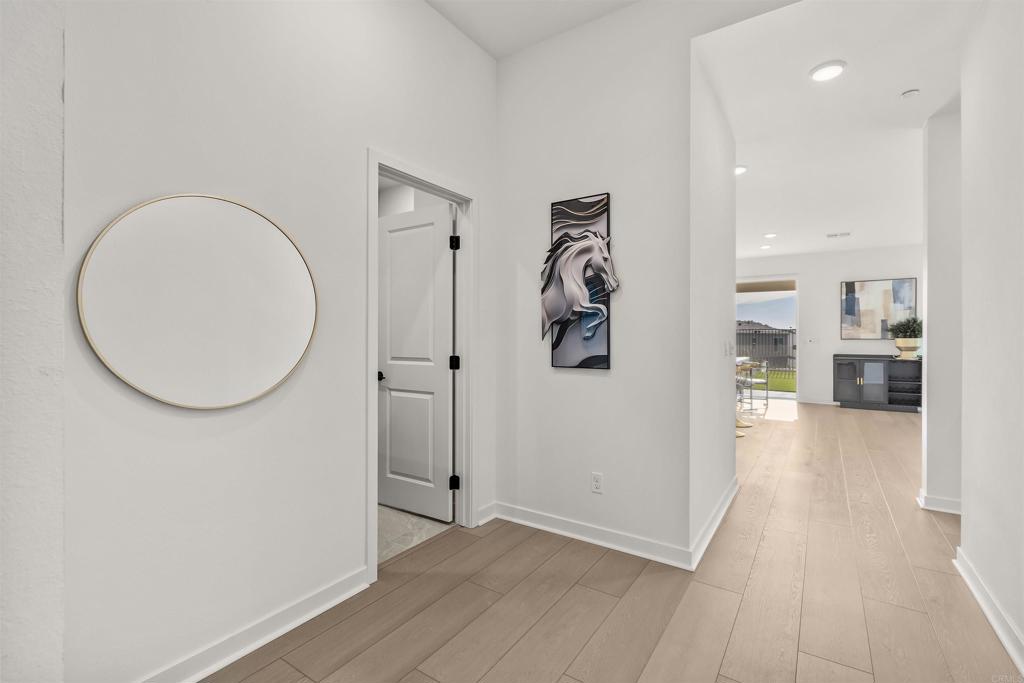550 Meadowood Street Fallbrook, CA 92028 - Photo 21 of 37 a view of a furniture and a kitchen with wooden floor