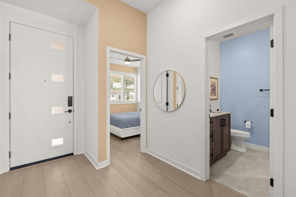 550 Meadowood Street Fallbrook, CA 92028 - Photo 22 of 37 a view of bathroom with a toilet a sink and a mirror