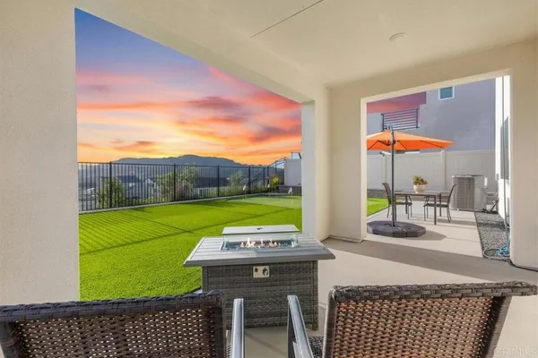 a swimming pool with a yard and outdoor seating