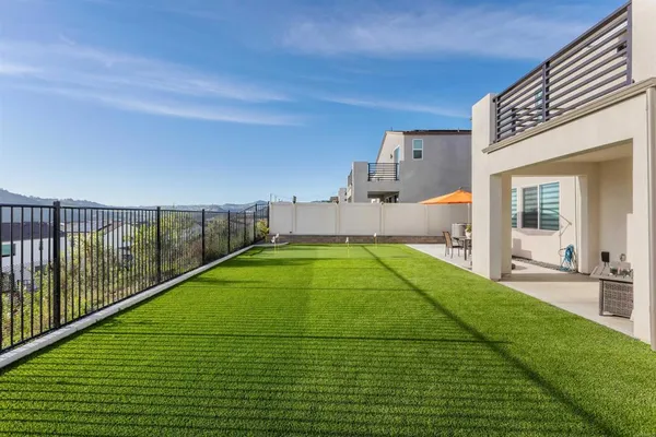 a view of a house with backyard porch and sitting area