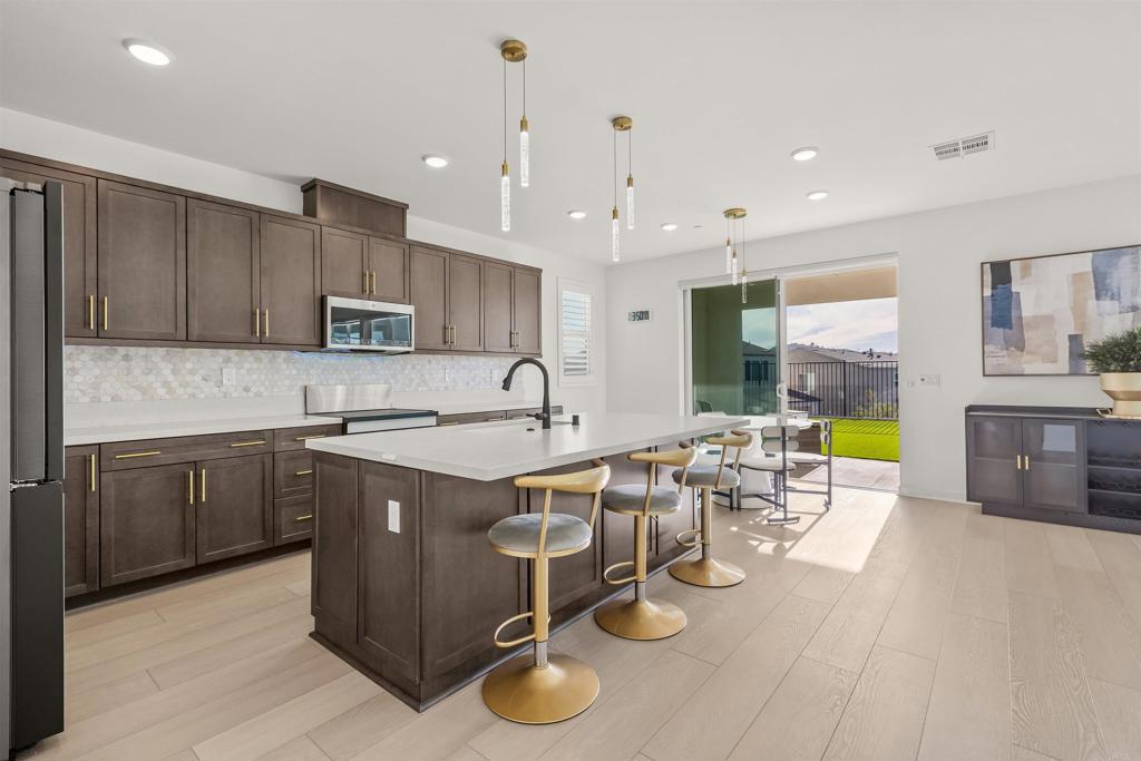 550 Meadowood Street Fallbrook, CA 92028 - Photo 4 of 37 a kitchen with a sink appliances and cabinets