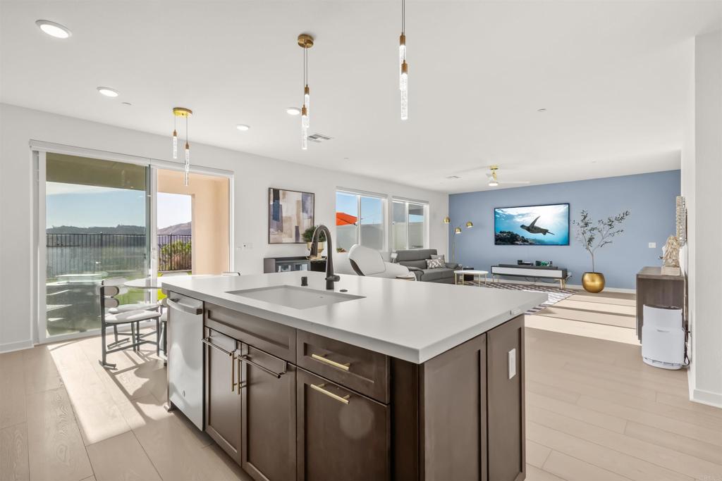 550 Meadowood Street Fallbrook, CA 92028 - Photo 5 of 37 a large kitchen with kitchen island a sink table and chairs