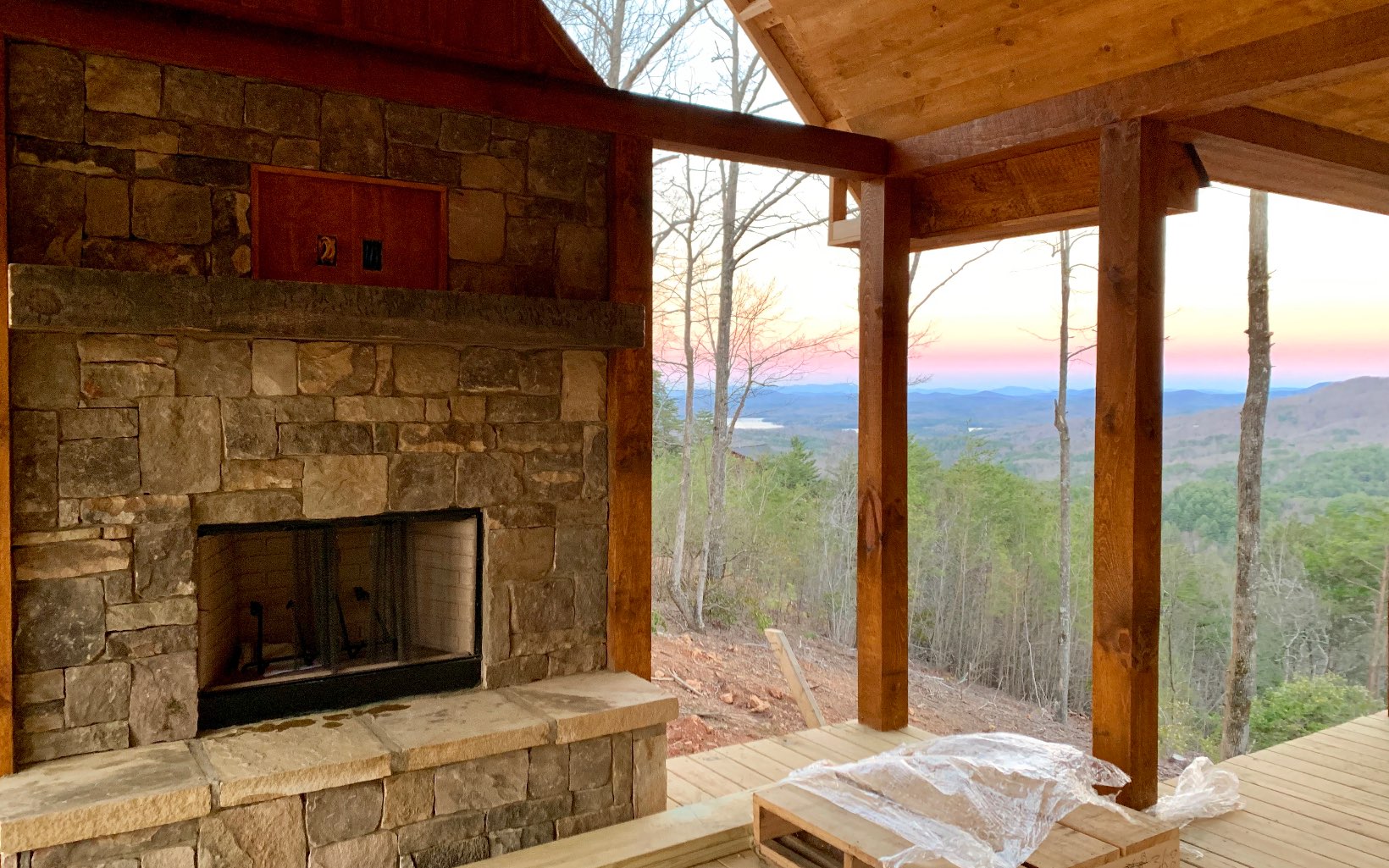 4 Spirit Mountain Road Blue Ridge, GA 30513 - Photo 1 of 1 a living room with a fireplace and a floor to ceiling window