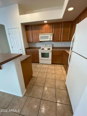 a kitchen with a stove a refrigerator and a sink