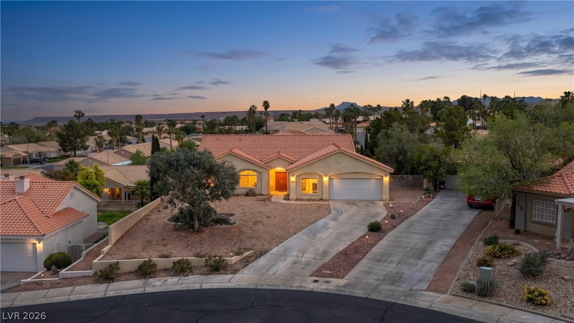 649 Rancho Circle Mesquite, NV 89027 - Photo 1 of 73 This charming residence features a classic tile roof and an inviting entrance, surrounded by desert landscaping.