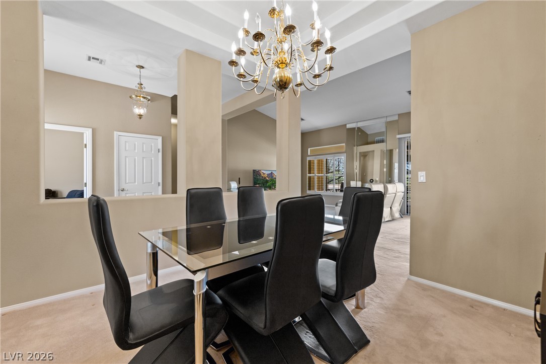 649 Rancho Circle Mesquite, NV 89027 - Photo 13 of 73 This bright dining area features an elegant chandelier and open layout, perfect for entertaining.