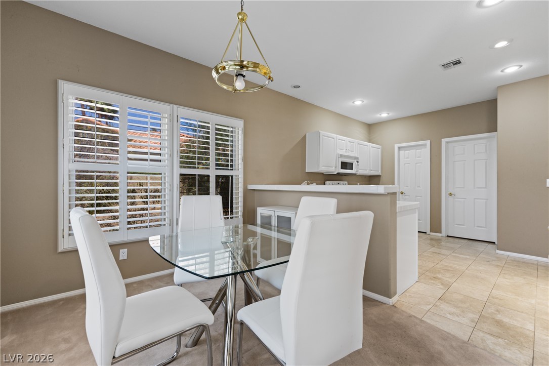 649 Rancho Circle Mesquite, NV 89027 - Photo 18 of 73 Bright dining area with convenient kitchen access features elegant tile flooring.
