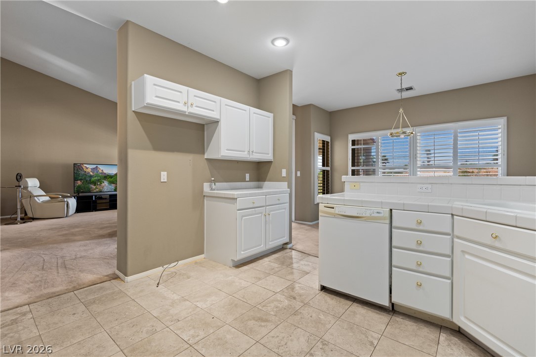 649 Rancho Circle Mesquite, NV 89027 - Photo 22 of 73 This spacious kitchen with tiled floors offers abundant cabinetry and a pass-through to the living area.