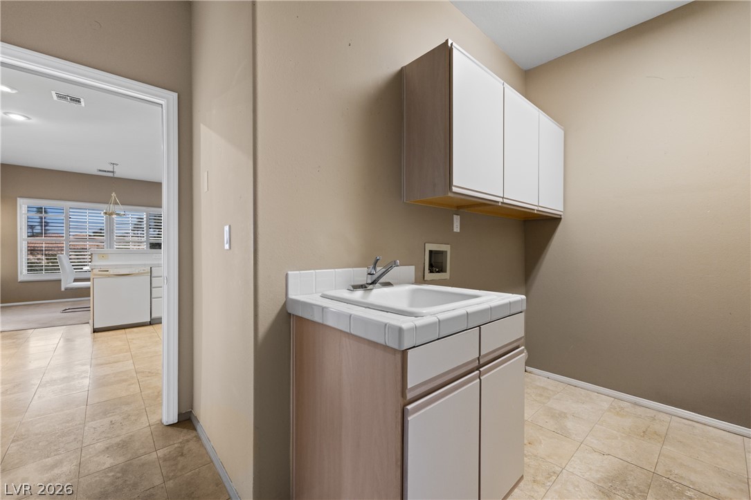 649 Rancho Circle Mesquite, NV 89027 - Photo 26 of 73 This functional laundry room features convenient storage and durable tile flooring.