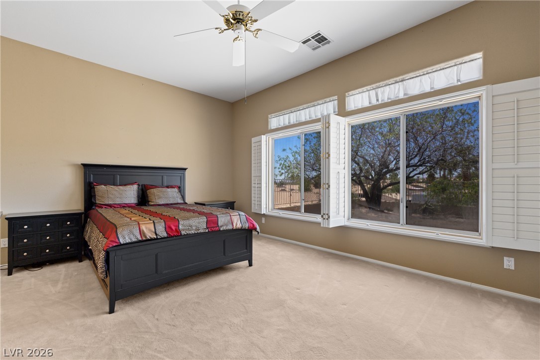 649 Rancho Circle Mesquite, NV 89027 - Photo 34 of 73 This inviting bedroom features ample natural light, soft carpet, and a vaulted ceiling for a spacious feel.