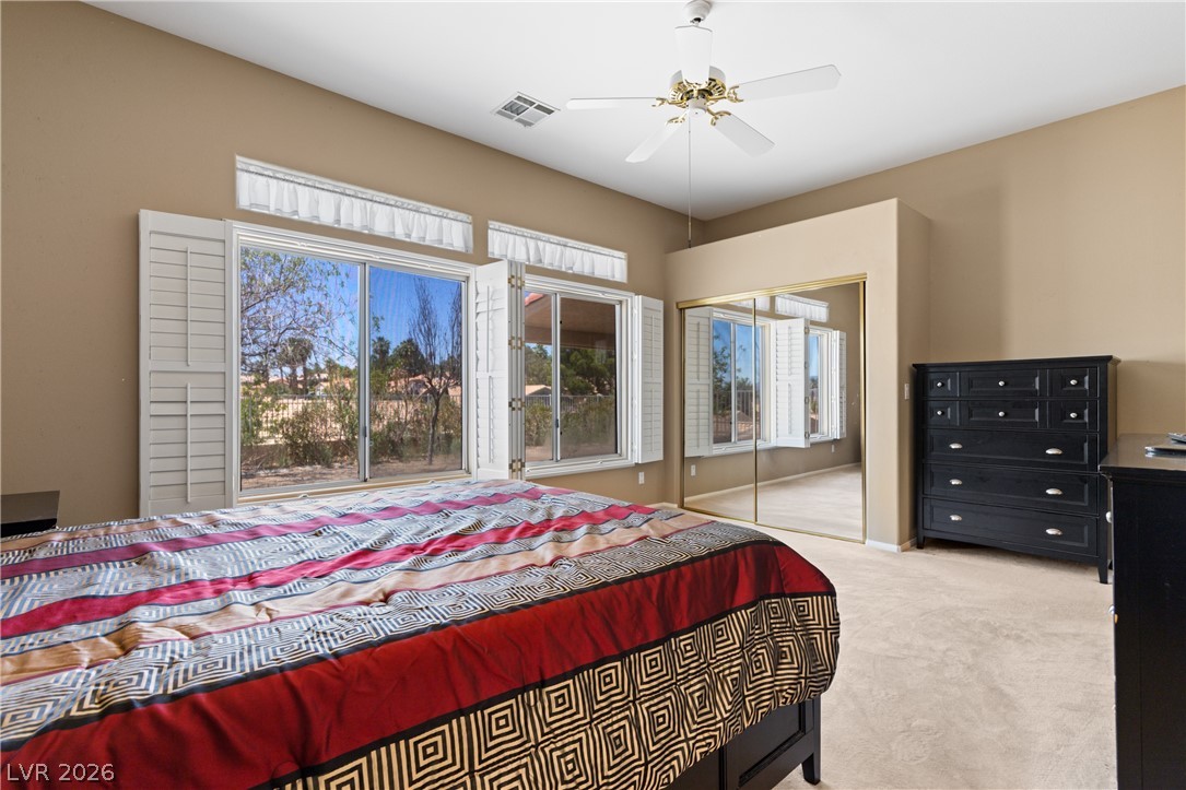 649 Rancho Circle Mesquite, NV 89027 - Photo 35 of 73 This spacious bedroom offers ample natural light and direct access to outdoor views.