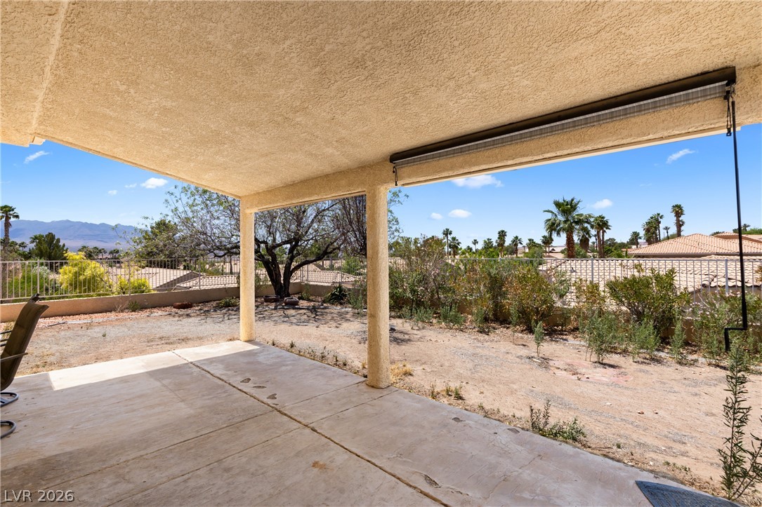 649 Rancho Circle Mesquite, NV 89027 - Photo 39 of 73 This covered patio offers a refreshing retreat with desert landscaping and distant mountain views.