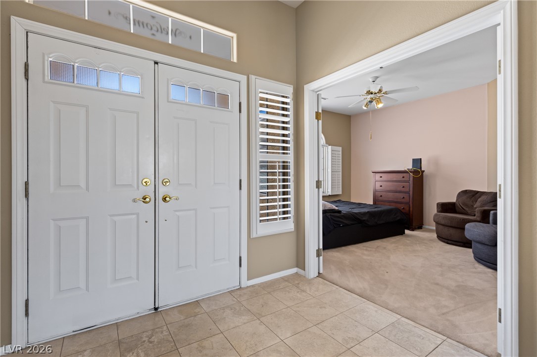 649 Rancho Circle Mesquite, NV 89027 - Photo 4 of 73 The inviting entrance features double doors, opening into a versatile space with neutral flooring.