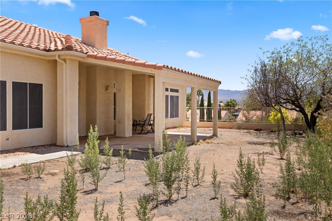649 Rancho Circle Mesquite, NV 89027 - Photo 42 of 73 This spacious backyard offers mountain views and a covered patio, perfect for outdoor enjoyment.